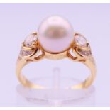 An 18 ct gold, diamond and pearl ring. Ring size L/M. 3.9 grammes total weight.