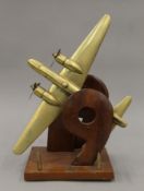 A brass model of a Wellington bomber from the 99th squadron mounted on a wooden plinth base with