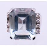 A 14 K white gold, diamond and aquamarine ring. Ring size O/P. 7.9 grammes total weight.