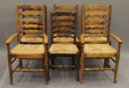 Six ladder-back dining chairs, including two carvers. The latter each 56 cm wide.