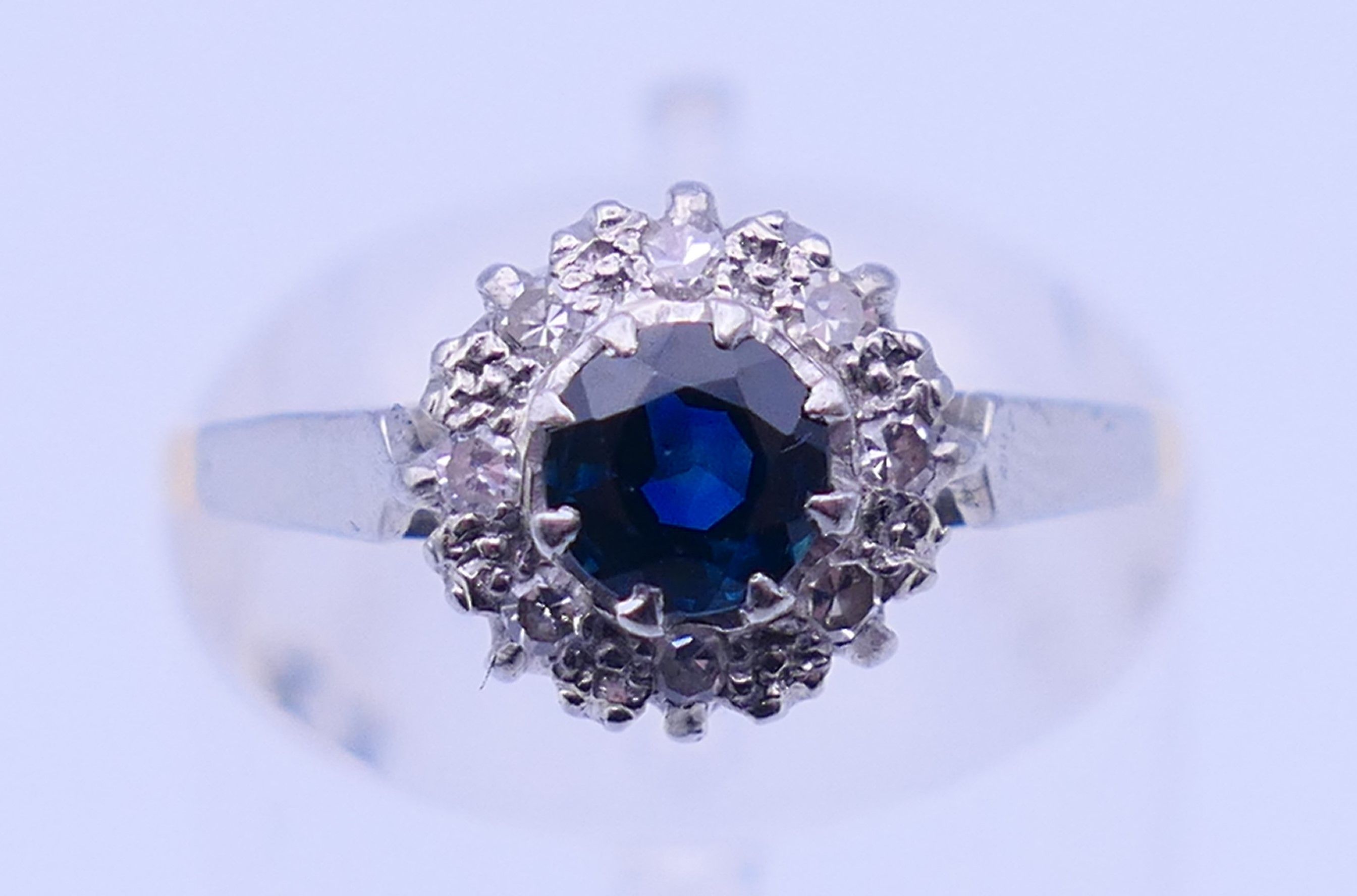 An 18 ct gold and platinum diamond and sapphire ring. Ring size M. 2.4 grammes total weight.