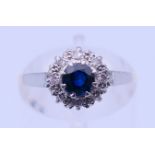 An 18 ct gold and platinum diamond and sapphire ring. Ring size M. 2.4 grammes total weight.