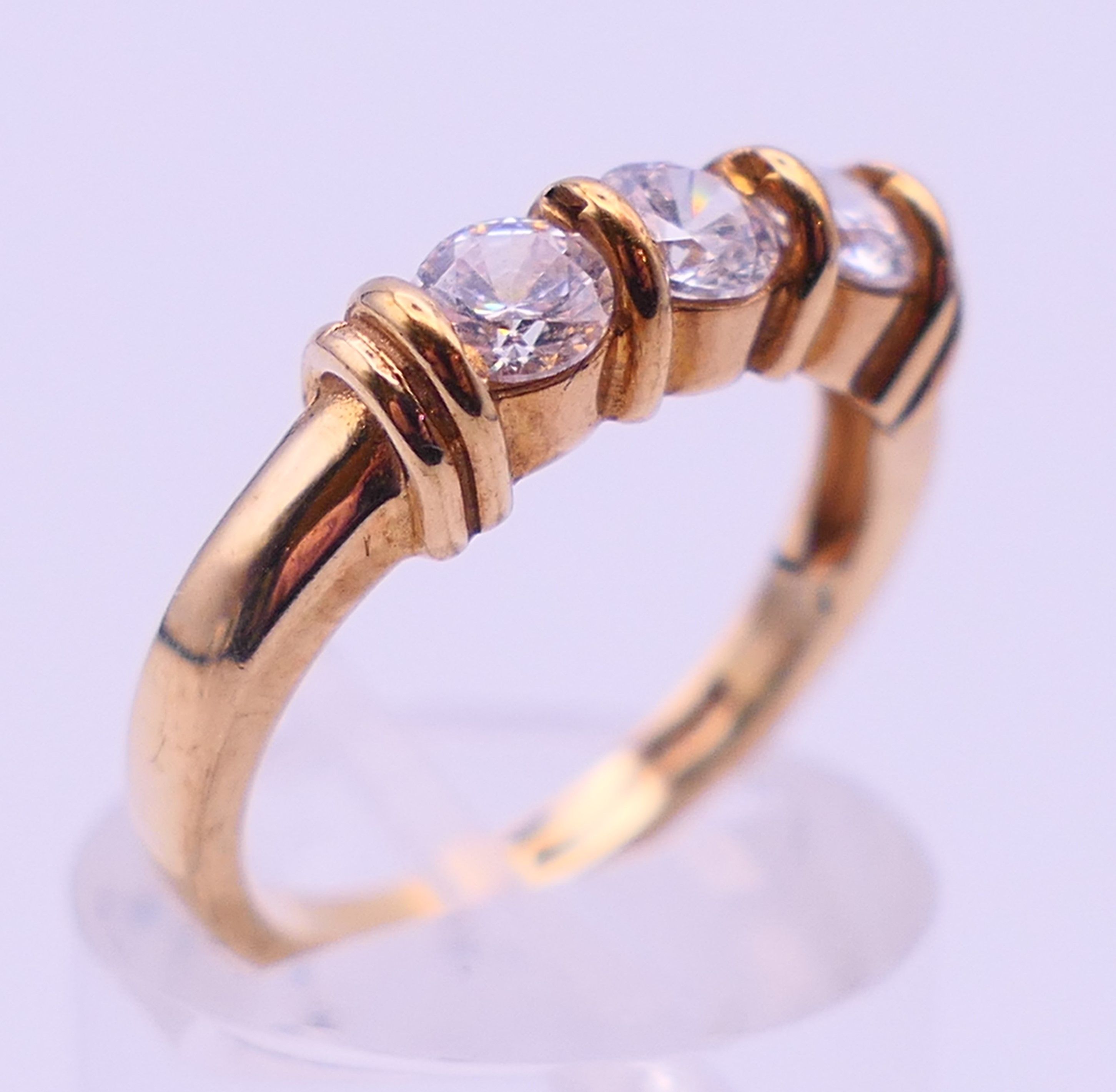 A 9 ct gold three-stone ring and an unmarked half hoop eternity ring. The former, Ring size M and 3. - Image 9 of 11