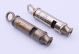 Two vintage Metropolitan Police whistle, one made by J Hudson & Co, Birmingham. Both 8 cm long.