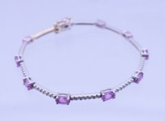 An 18 ct white gold, pink sapphire and diamond bracelet. 16 cm long. 6.9 grammes total weight.