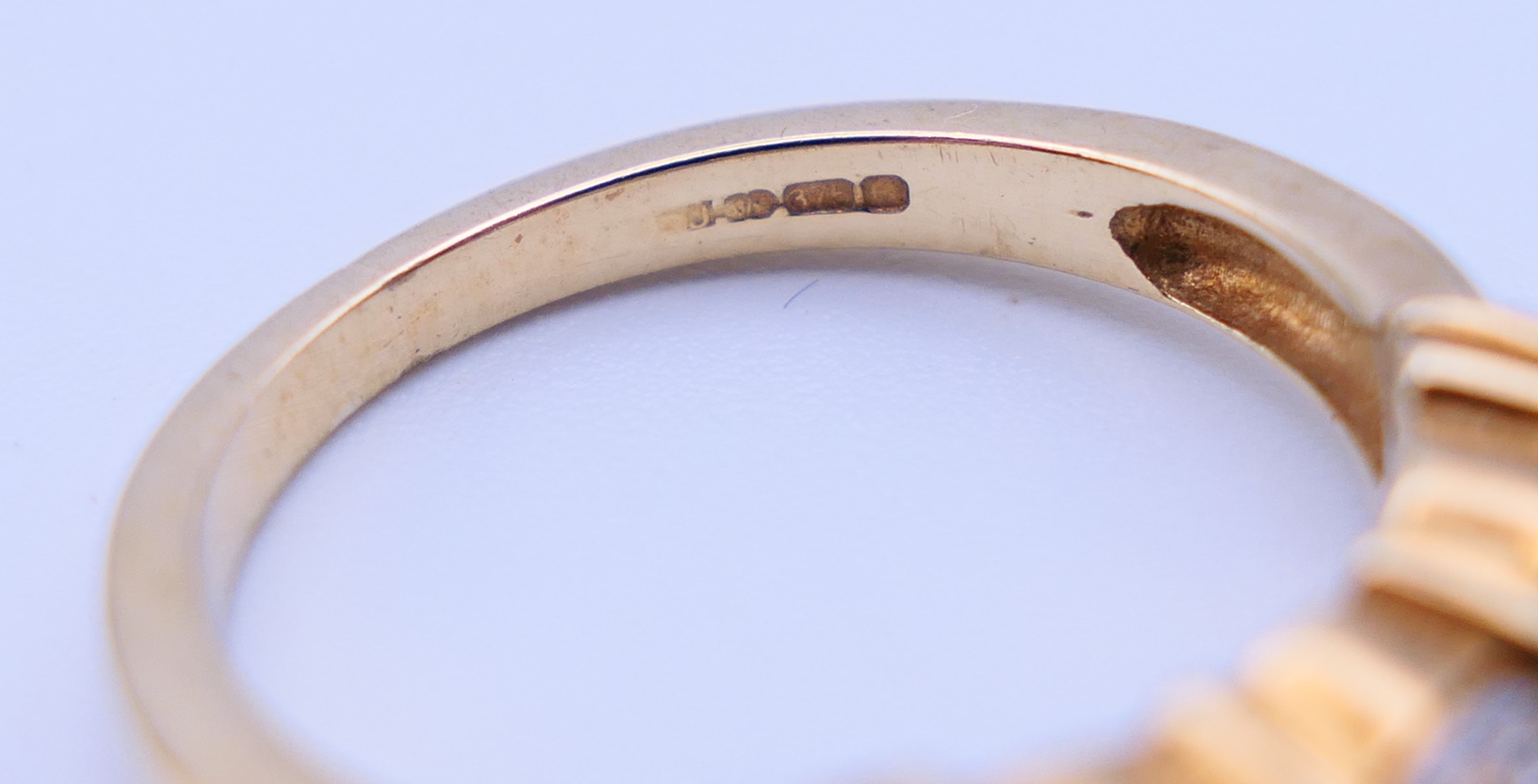 A 9 ct gold three-stone ring and an unmarked half hoop eternity ring. The former, Ring size M and 3. - Image 10 of 11