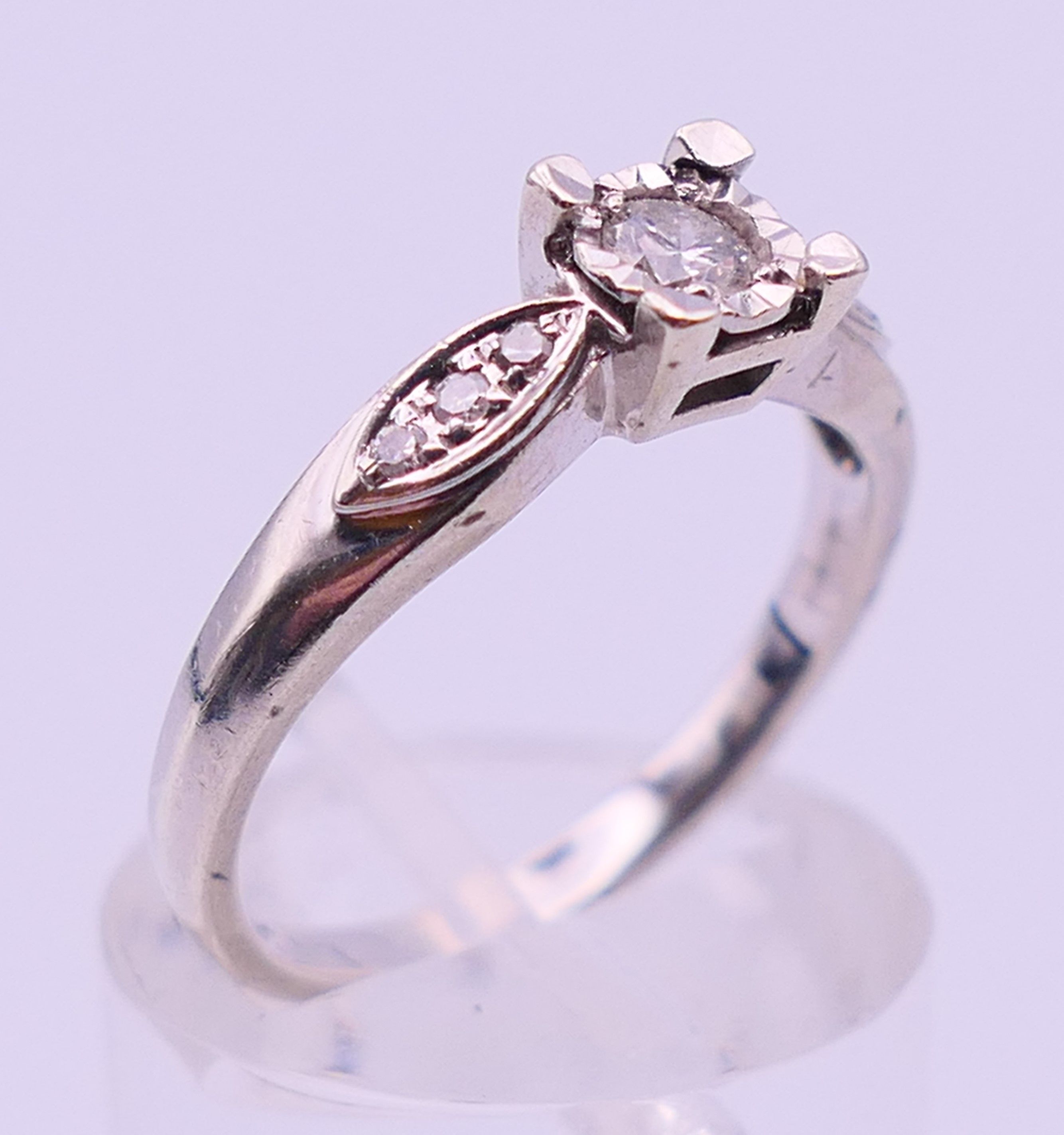 A 9 ct white gold and 0.20 carat diamond ring. Ring size N/O. 2.9 grammes total weight. - Image 3 of 5