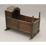 An 18th/19th century oak crib. 94 cm long.