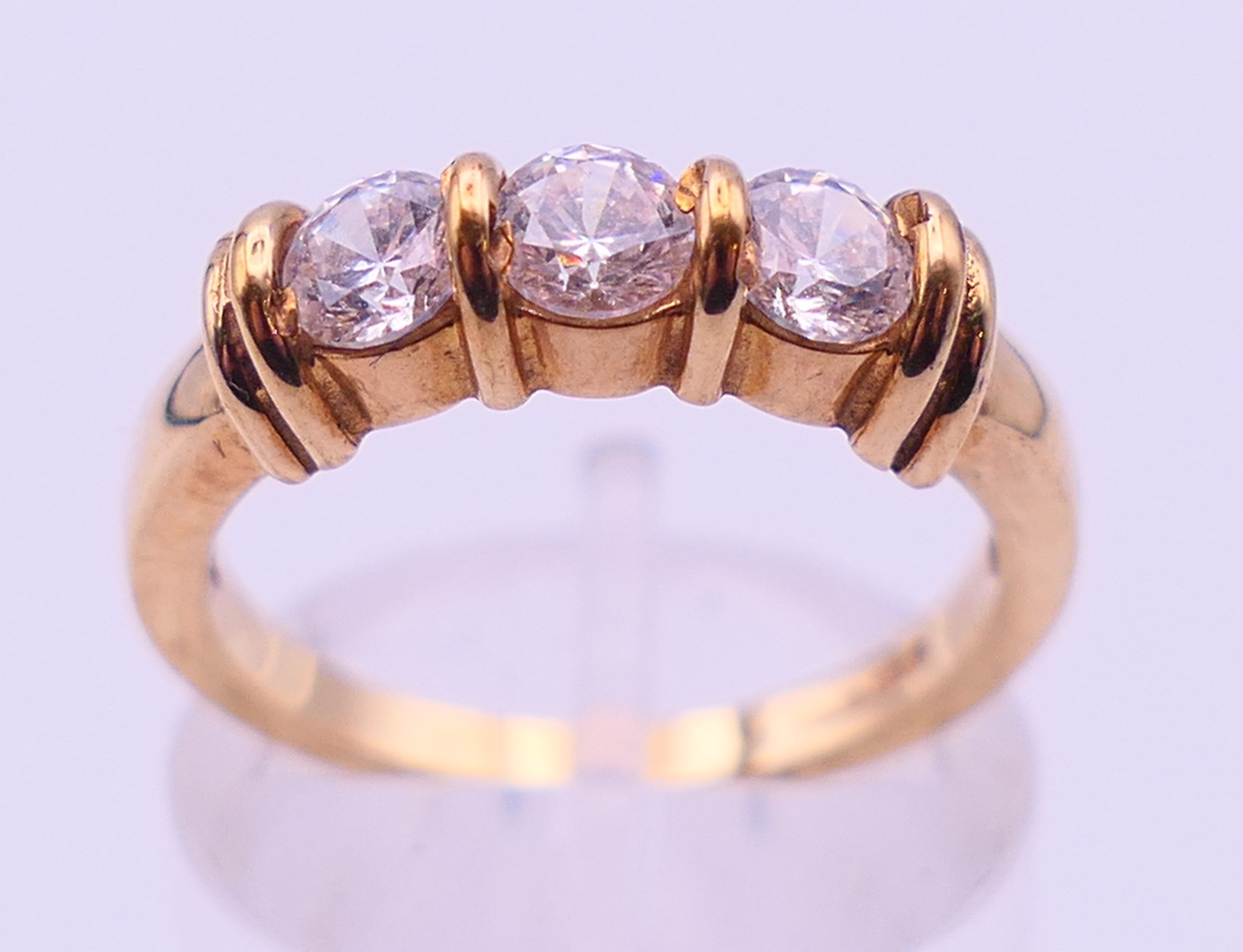 A 9 ct gold three-stone ring and an unmarked half hoop eternity ring. The former, Ring size M and 3. - Image 8 of 11