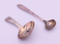 A Georgian silver caddy spoon and a mustard spoon. 7.5 cm high and 10 cm high respectively.