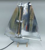 A classic 1930's design Bunting & Co electric fire formed as a yacht with chrome sails. 77 cm high.
