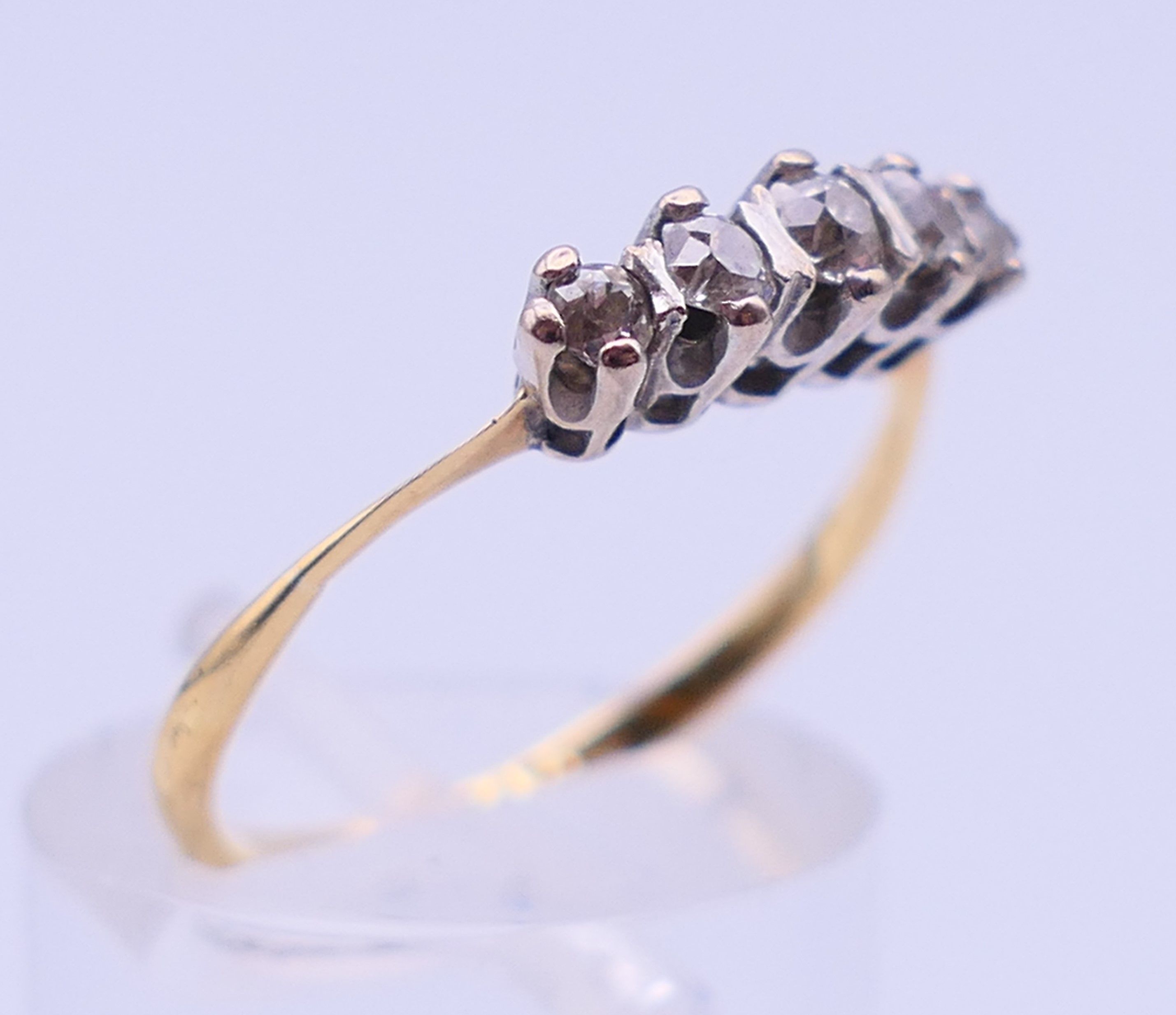 An 18 ct gold and platinum five-stone diamond ring. Ring size N/O. 2.1 grammes total weight. - Image 3 of 5