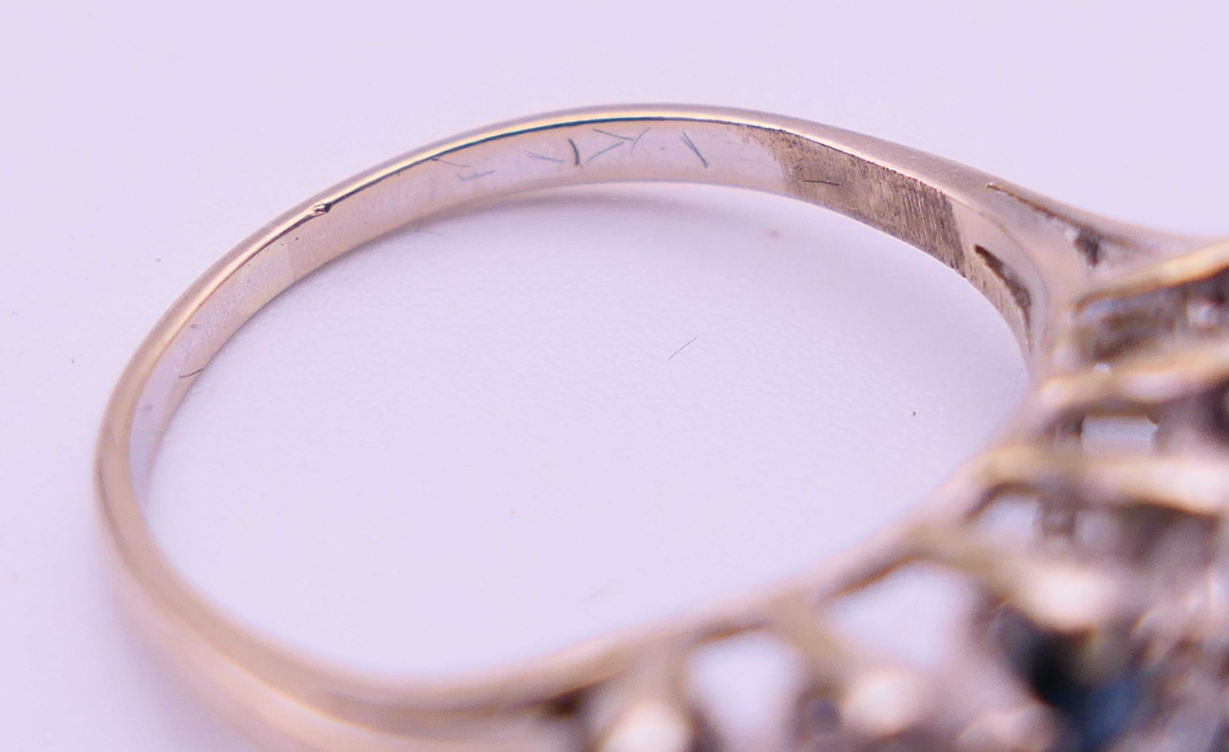 An unmarked white gold or platinum, diamond and sapphire ring. Ring size N. 4 grammes total weight. - Image 4 of 5