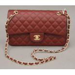 A red leather Chanel handbag. 25 cm wide.
