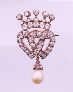 An unmarked diamond and pearl drop brooch, formed as entwined hearts beneath a coronet. 3.5 cm high.
