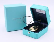 A boxed Tiffany & Co Elsa Peretti 18 ct gold disc pendant necklace. Pendant 3.