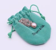 A Tiffany & Co silver chain with pearl pendant, in Tiffany bag.
