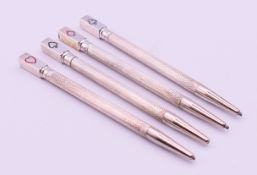 A cased set of four silver bridge pencils. Each 8.5 cm high.