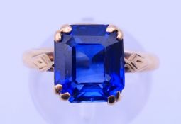 An 18 or 22 ct gold and synthetic sapphire ring. 4.3 grammes total weight.