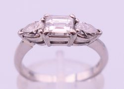 A platinum three-stone diamond ring with European Gemological Laboratory certificate.