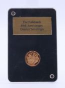 A boxed Falklands 40th Anniversary 2022 gold quarter sovereign.