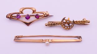 A 9 gold three-stone bar brooch and two unmarked gold bar brooches. 9 ct gold three-stone brooch 3.