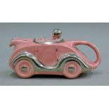 An Art Deco-style pottery racing car teapot. 21 cm long.