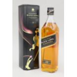 A tin containing a 70 cl bottle of Johnnie Walker Black Label 12 Year old whisky.