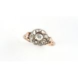 A Georgian diamond ring, the centre oval rose cut diamond set within a border eight smaller rose cut