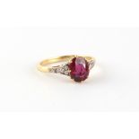 An 18ct yellow gold unheated Thai ruby & diamond ring, the oval cushion cut ruby weighing
