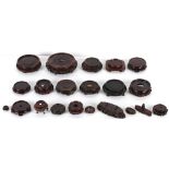 Property of a lady - a collection of twenty-one Chinese carved hardwood stands, 19th century and