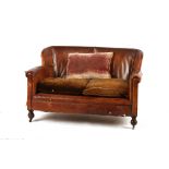 Property of a deceased estate - a small 1920's distressed leather upholstered sofa, on bun feet &