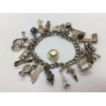 A Double Curb Link Charm Bracelet, to hallmarked silver heart shape padlock style clasp,
