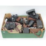 Cameras, including SLR, folding, box and rangefinder, plus lenses; examples include Nikon F-601 with