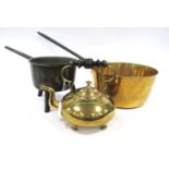 A Late XIX Century Brass Saucepan, with a long metal handle, another raised on three short feet, and