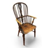 A XIX Century Windsor Chair, with a hooped peicred splat, rail supports on turned supports, united