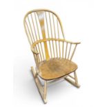 Ercol Light Wood Rocking Chair with waisted central splat and spindle back, bearing label, 103cm
