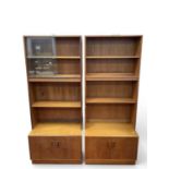 A Pair of G Plan Fresco Teak High Backed Two Door Cupboards, one back featuring three shelves, two