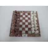 A hand-carved marble/alabaster chess set with matching inlaid stone chessboard, chessboard 24.5x24.