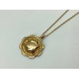 A 9ct Gold Medallion Pendant, T. D. N & S Ltd, Birmingham 1920, of decorative foliate engraved