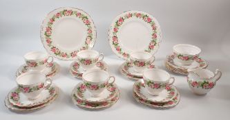 A Colclough tea service decorated roses comprising six cups and saucers, twelve side plates, cake