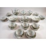 A Japanese eggshell tea service painted birds and blossom comprising teapot, jug, sugar, ten
