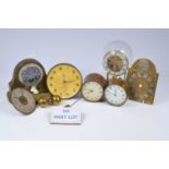 A collection of clocks and clock parts and other items,