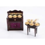 Two 19th century pieces of Waltershausen dolls’ house furniture and a turned wooden tea set,