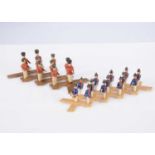 Two early 19th century Erzgebirge wooden military scissor toy,