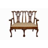 A contemporary Chippendale style two seater settee,