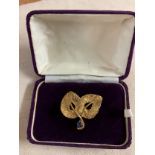 Cartier brooch, floral pattern of two leaves with a Sapphire set to the stem, signed to the back