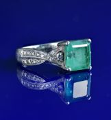 A platinum ring set with a Colombian emerald cut emerald of approximately 2.8ct and diamonds (