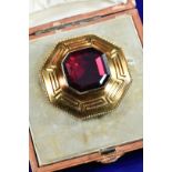 Victorian yellow metal octagonal brooch with Greek key decoration set with an octagonal foiled