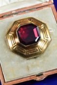 Victorian yellow metal octagonal brooch with Greek key decoration set with an octagonal foiled